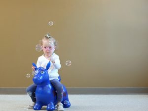 girl playing with bubbles