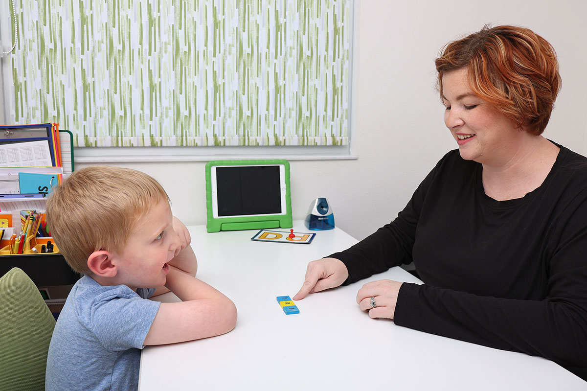 woman and girl working on literacy services together